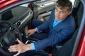 Male person is testing car in autosalon Royalty Free Stock Photo