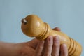 Adult man holds in his hand a wooden pepper mill Royalty Free Stock Photo