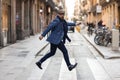 Adult man jumping in pedestrian crossing of street in Barcelona