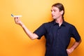 Adult man loking at his toy airplane in his right hand