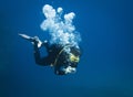 Scuba diver taking underwater photo in deep blue water Royalty Free Stock Photo