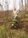 Adult man plowing spring yard Royalty Free Stock Photo