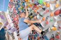 Adult man practicing rock climbing on climbing wall Royalty Free Stock Photo