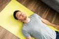 Adult man relaxing with a yoga routine at home Royalty Free Stock Photo