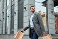 Adult man with shopping bags in city