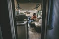 Adult man sitting inside van camper motorhome. Tourist of alternaive people lifestyle. Travel and enjoying freedom. Holiday Royalty Free Stock Photo