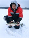 The adult man smiles and shows the newly caught pike perch. Royalty Free Stock Photo