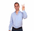 Adult man smiling and showing you victory sign Royalty Free Stock Photo