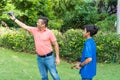 Adult man with son playing with drone in park