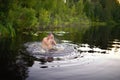 Adult man splash water in forest lake Royalty Free Stock Photo