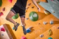 adult man in sportswear climbing rock wall indoor. Concept of sport life.