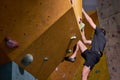 adult man in sportswear climbing rock wall indoor. Concept of sport life.