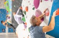 Adult man practicing rock climbing on climbing wall Royalty Free Stock Photo