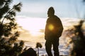 Adult man standing and looking the sunset enjoying freedom and healthy lifestyle outdoor - nature and travel people with sunlight