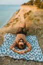 Adult man in sweater and sunglasses chilling on blanket outdoors