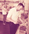 Adult man taking with scoop cereals sold Royalty Free Stock Photo