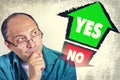 Adult man thinking what to choose between YES and NO