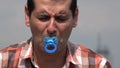 Adult Man Using Baby Pacifier