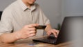 Adult man using laptop to register via credit card to shop online. Credit card secure online shopping and payment. Royalty Free Stock Photo