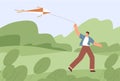 Adult man walking with flying air kite outdoors. Person holding it with string and fly to sky. Happy guy playing with Royalty Free Stock Photo