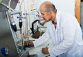 Adult man in white coat making tests