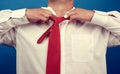 Adult man in a white office shirt tears off a red satin tie from his neck on a blue background Royalty Free Stock Photo