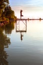 Adult man in yoga position on the pier