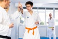 Adult and young men training karate fight