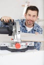 adult master sawing platband with circular saw indoors