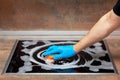 Men`s hand in blue glove clean kitchen electric stove with a sponge and cleansing foam Royalty Free Stock Photo