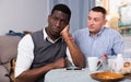 Man apologizing to his African friend Royalty Free Stock Photo