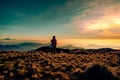 An adult mountainer standing at the peak of Mt. Pulag enjoying the breathtaking view of sea of clouds during sunrise Royalty Free Stock Photo