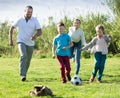 Adult parents with two kids playing soccer Royalty Free Stock Photo