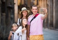 Adult parents with two kids taking selfie