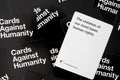 Adult party game cards against humanity scattered white and black cards referencing human rights Royalty Free Stock Photo