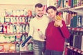 Adult people selecting detergents in the store Royalty Free Stock Photo