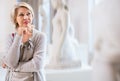 Adult female looking at artwork sculpture in the museum indoors