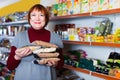 Adult positive woman buyer with assortment of buckwheat food store