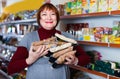 Adult positive woman buyer with assortment of buckwheat food store