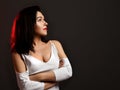 Adult pretty brunette woman with healthy skin in white stylish blouse standing with arms crossed at chest looking aside Royalty Free Stock Photo