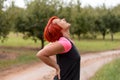 Adult Redhead Woman Holding her Painful Lower Back Royalty Free Stock Photo