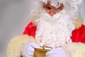 Adult santa claus with white beard holding wallet with money, christmas concept, waiting for gifts, sales and discounts, festive