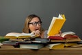 Adult shocked woman in glasses stunned with information in book Royalty Free Stock Photo