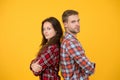 Adult siblings. Sister and brother. Confident team. Back to back standing man and woman. Fashion clothes shop. Modern Royalty Free Stock Photo