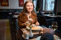 Adult smiling caucasian woman and partial man eating pasta in hotel restaurant Royalty Free Stock Photo