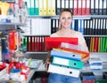 Adult smiling woman standing with folders Royalty Free Stock Photo