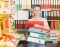 Adult smiling woman standing with folders Royalty Free Stock Photo