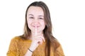 Adult smiling young woman holding shh finger on her lips over white background Royalty Free Stock Photo