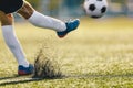 Adult Soccer Player Kicking Ball On Sunny Day on Artificial Football Pitch