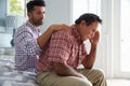 Adult Son Comforting Father Suffering With Dementia Royalty Free Stock Photo